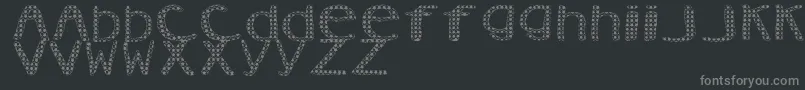 AezVanity-fontti – harmaat kirjasimet mustalla taustalla
