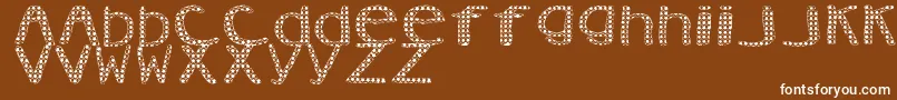 Czcionka AezVanity – białe czcionki na brązowym tle