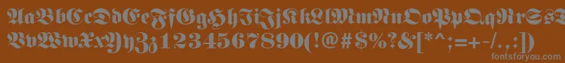 LunariRegular-fontti – harmaat kirjasimet ruskealla taustalla