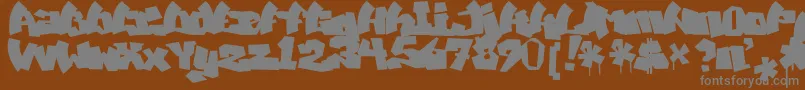MawnsGraffitiFilled-Schriftart – Graue Schriften auf braunem Hintergrund