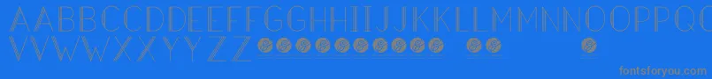 フォントHazeldecolightRegular – 青い背景に灰色の文字