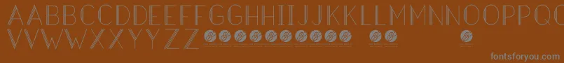 HazeldecolightRegular-Schriftart – Graue Schriften auf braunem Hintergrund