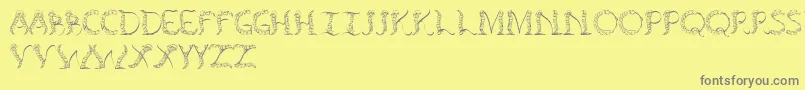 フォントTenchceliber – 黄色の背景に灰色の文字