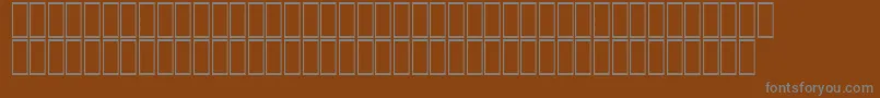 Czcionka AcsTopazzExtraBold – szare czcionki na brązowym tle