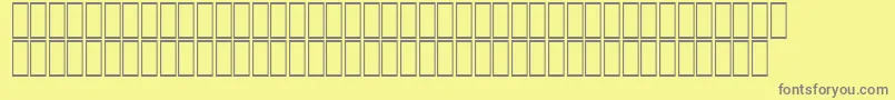 AcsTopazzExtraBold-fontti – harmaat kirjasimet keltaisella taustalla