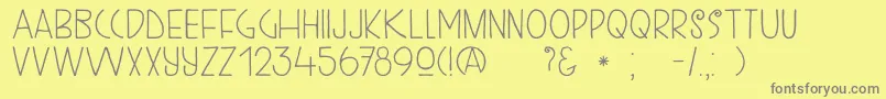 フォントDkKunstschau – 黄色の背景に灰色の文字