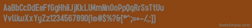TesBoldР™-fontti – harmaat kirjasimet ruskealla taustalla