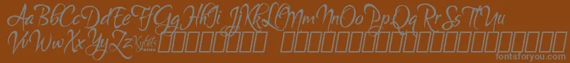 フォントKyletsDemo – 茶色の背景に灰色の文字