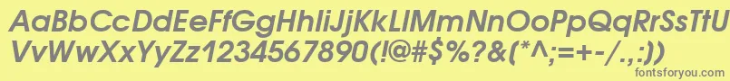 AvantgardegothicattBolditalic-fontti – harmaat kirjasimet keltaisella taustalla