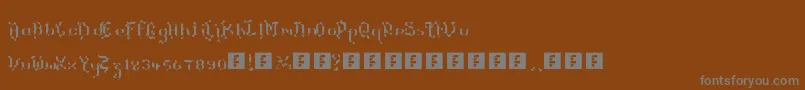 TheTerrifficKerganogggg-fontti – harmaat kirjasimet ruskealla taustalla