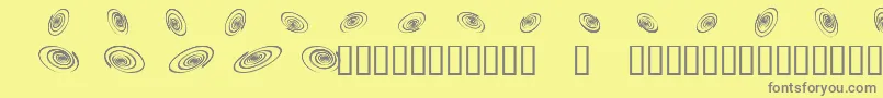 Omegaswirls-fontti – harmaat kirjasimet keltaisella taustalla