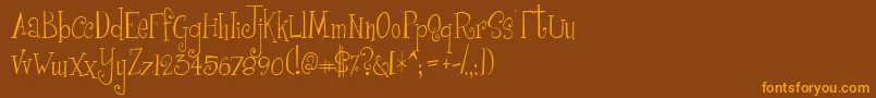 フォントGirlsAreWeird – オレンジ色の文字が茶色の背景にあります。