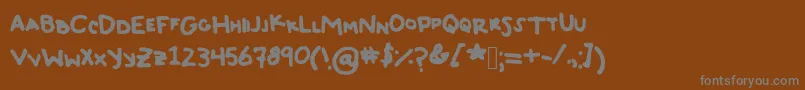 フォントTyeDyeJerky – 茶色の背景に灰色の文字