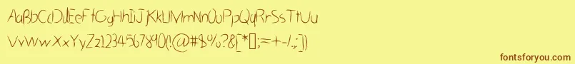 フォントHastygrassVl – 茶色の文字が黄色の背景にあります。