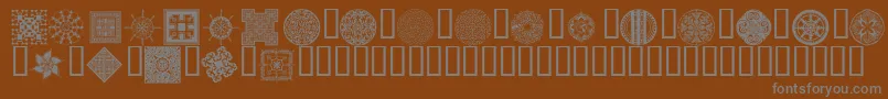 Wmdesigns2-Schriftart – Graue Schriften auf braunem Hintergrund