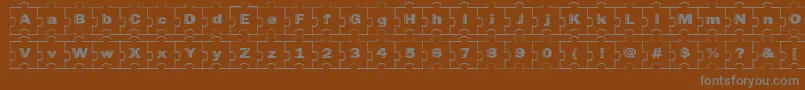 Fonte Failedfont2jigsaw – fontes cinzas em um fundo marrom