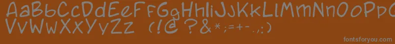 Czcionka Caricature.Fr – szare czcionki na brązowym tle
