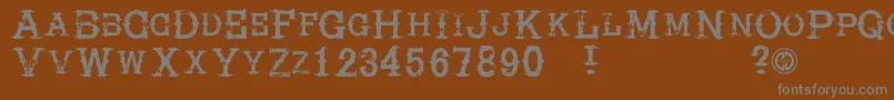 Hireacowboy Font – Gray Fonts on Brown Background