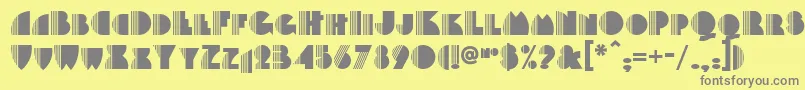 Backstage-fontti – harmaat kirjasimet keltaisella taustalla