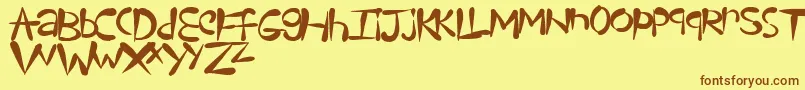 フォントTeardrops – 茶色の文字が黄色の背景にあります。