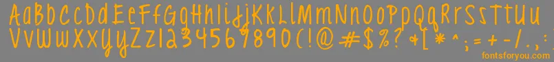 フォントKgloveyouthroughit3 – オレンジの文字は灰色の背景にあります。