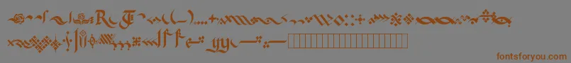 フォントKingthingsFlourishes – 茶色の文字が灰色の背景にあります。