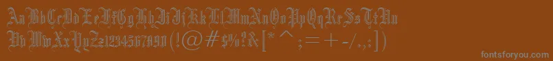 DrpoGothicru-Schriftart – Graue Schriften auf braunem Hintergrund