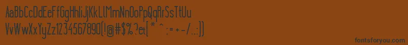YgraineSolid-Schriftart – Schwarze Schriften auf braunem Hintergrund