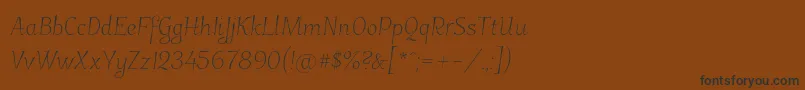 フォントGarineldo – 黒い文字が茶色の背景にあります