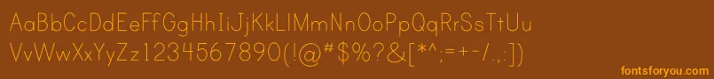 フォントPrintClearlyOt – オレンジ色の文字が茶色の背景にあります。