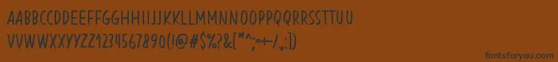 フォントBlessingInDisguiseRegular – 黒い文字が茶色の背景にあります