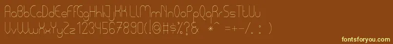 PycuafLightTfb-fontti – keltaiset fontit ruskealla taustalla