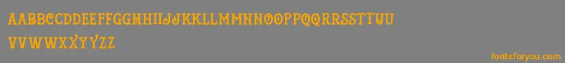 フォントTattooShop – オレンジの文字は灰色の背景にあります。