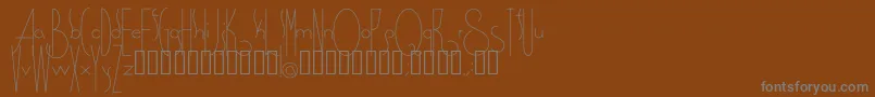 Spirituality-fontti – harmaat kirjasimet ruskealla taustalla