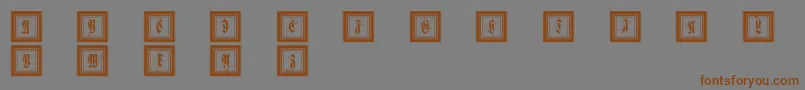 フォントFramedfraxcaps – 茶色の文字が灰色の背景にあります。