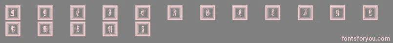 Framedfraxcaps-Schriftart – Rosa Schriften auf grauem Hintergrund