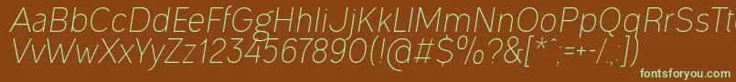 フォントOgonekLightItalic – 緑色の文字が茶色の背景にあります。