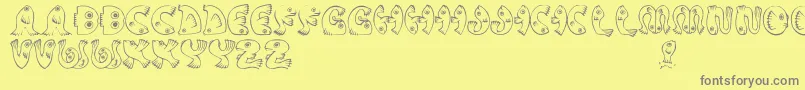 JmhPez-fontti – harmaat kirjasimet keltaisella taustalla
