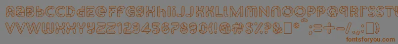 フォントSkrovapartsOutlinedotted1 – 茶色の文字が灰色の背景にあります。