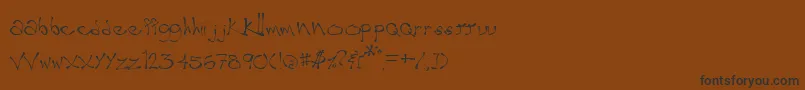 フォントWobble – 黒い文字が茶色の背景にあります