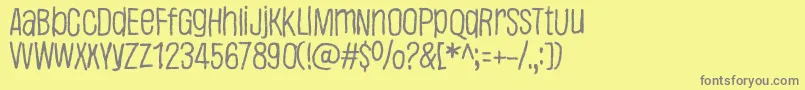 Justaword-fontti – harmaat kirjasimet keltaisella taustalla