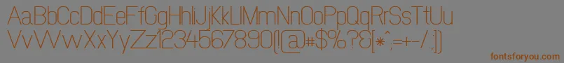 フォントNewmedia – 茶色の文字が灰色の背景にあります。