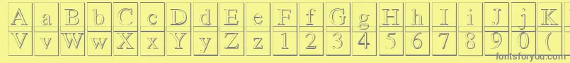 Romand3DDb-fontti – harmaat kirjasimet keltaisella taustalla