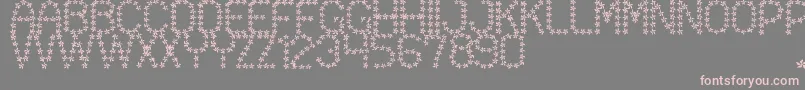 フォントFloweredSt – 灰色の背景にピンクのフォント