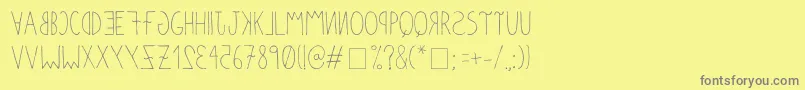 フォントAnomalias – 黄色の背景に灰色の文字