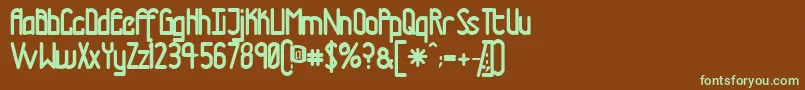 フォントTmtrn – 緑色の文字が茶色の背景にあります。