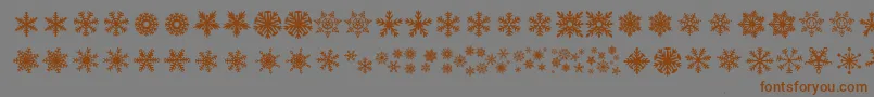 フォントDhSnowflakes – 茶色の文字が灰色の背景にあります。