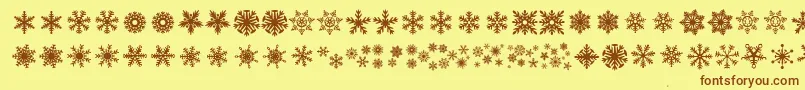 Fonte DhSnowflakes – fontes marrons em um fundo amarelo