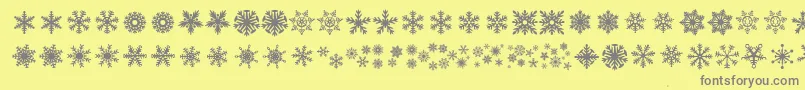 DhSnowflakes-Schriftart – Graue Schriften auf gelbem Hintergrund