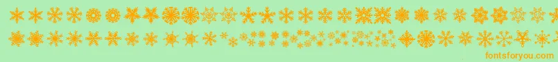 Czcionka DhSnowflakes – pomarańczowe czcionki na zielonym tle